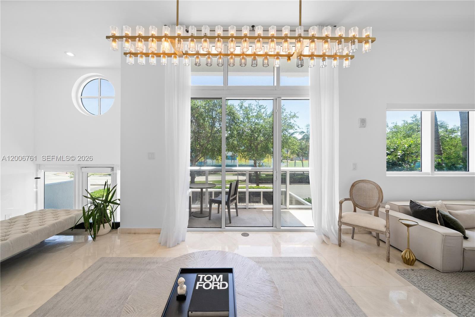 400 Alton Road, Unit TH1A Miami Beach, FL 33139 - Photo 13 of 32 a living room with furniture and a chandelier