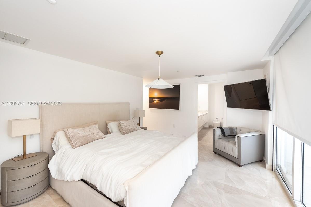 400 Alton Road, Unit TH1A Miami Beach, FL 33139 - Photo 19 of 32 a bedroom with a bed and flat screen tv