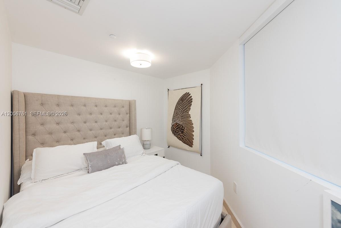 400 Alton Road, Unit TH1A Miami Beach, FL 33139 - Photo 23 of 32 a bed room with a bed and a mirror