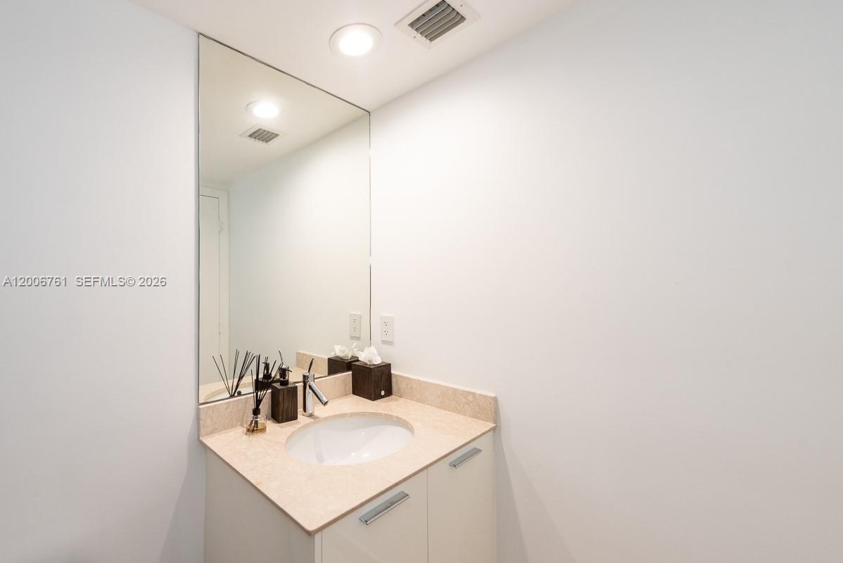 400 Alton Road, Unit TH1A Miami Beach, FL 33139 - Photo 24 of 32 a bathroom with a sink and a mirror