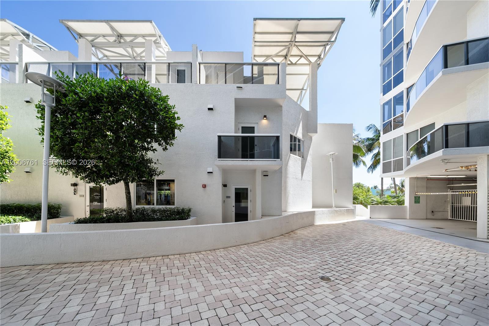 400 Alton Road, Unit TH1A Miami Beach, FL 33139 - Photo 25 of 32 a front view of a building with a yard