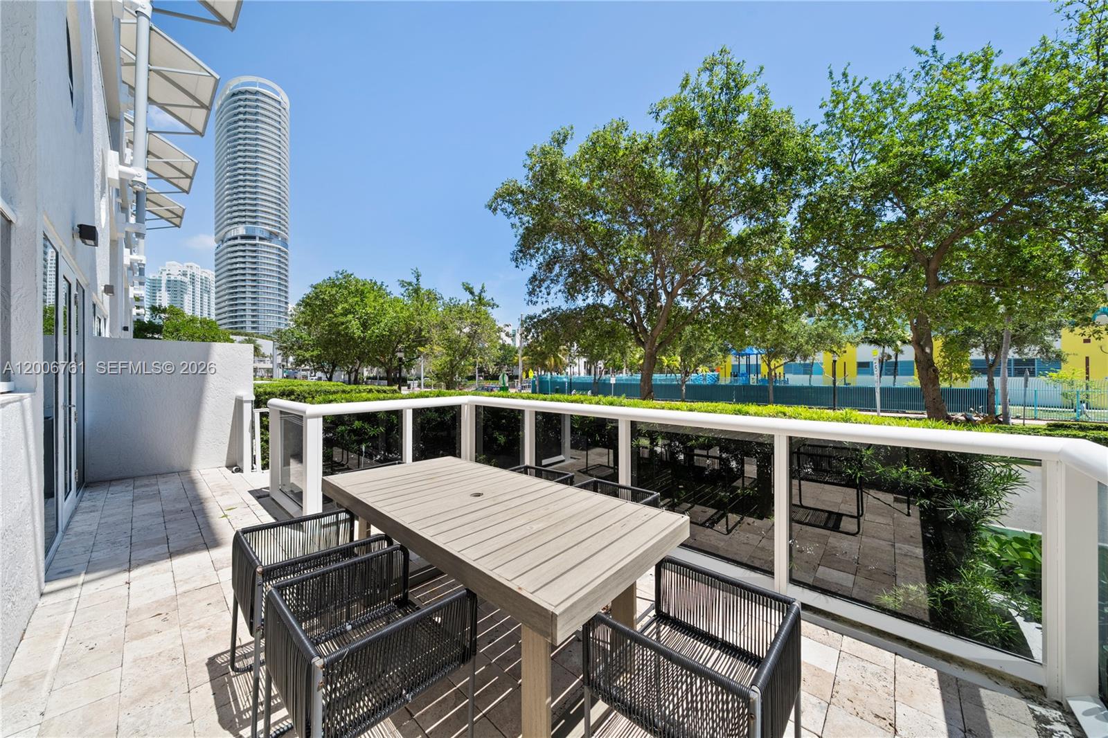 400 Alton Road, Unit TH1A Miami Beach, FL 33139 - Photo 5 of 32 a view of a patio with wooden floor and barbeque grill