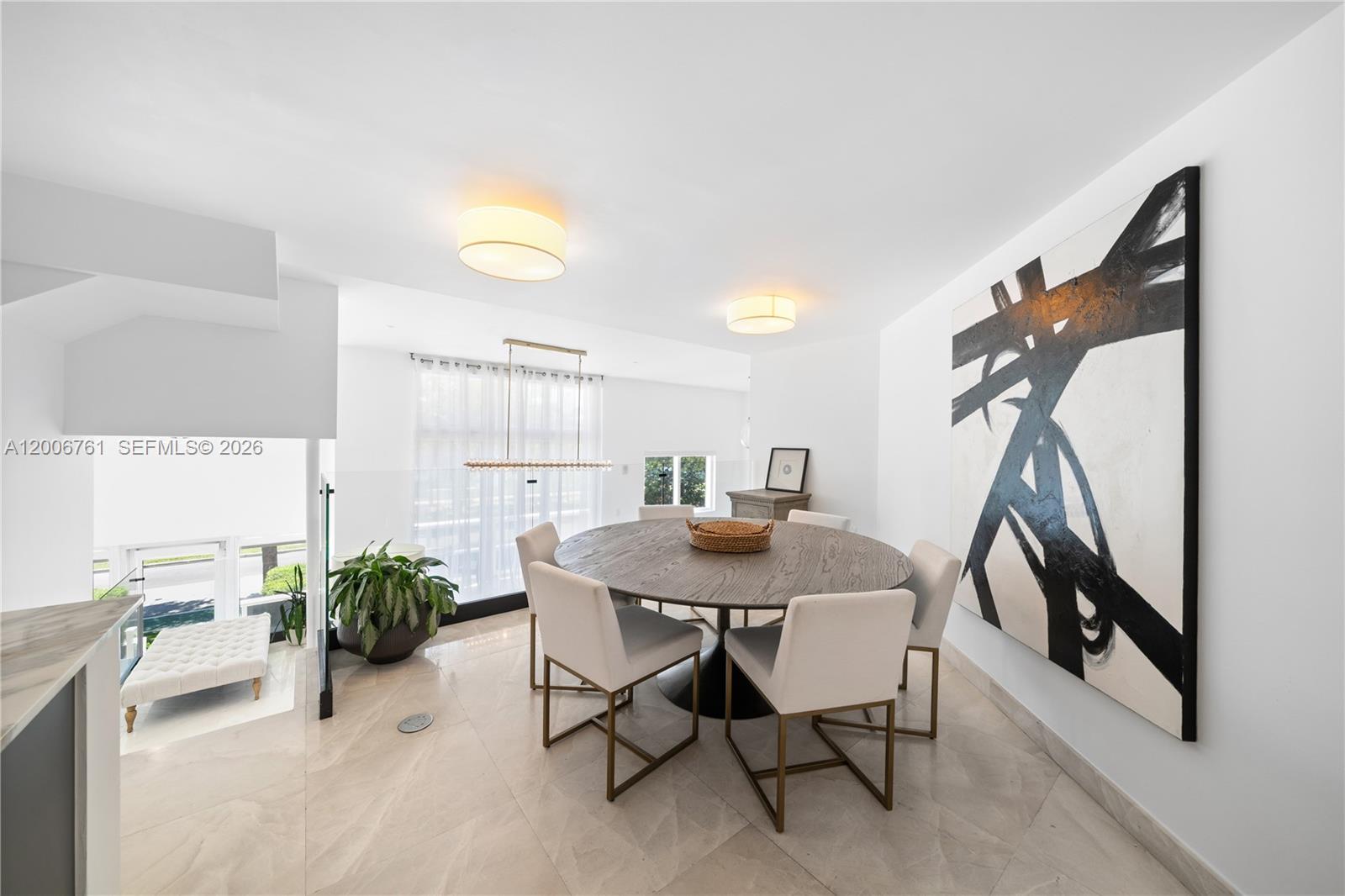 400 Alton Road, Unit TH1A Miami Beach, FL 33139 - Photo 7 of 32 a view of a dining room with furniture and a potted plant
