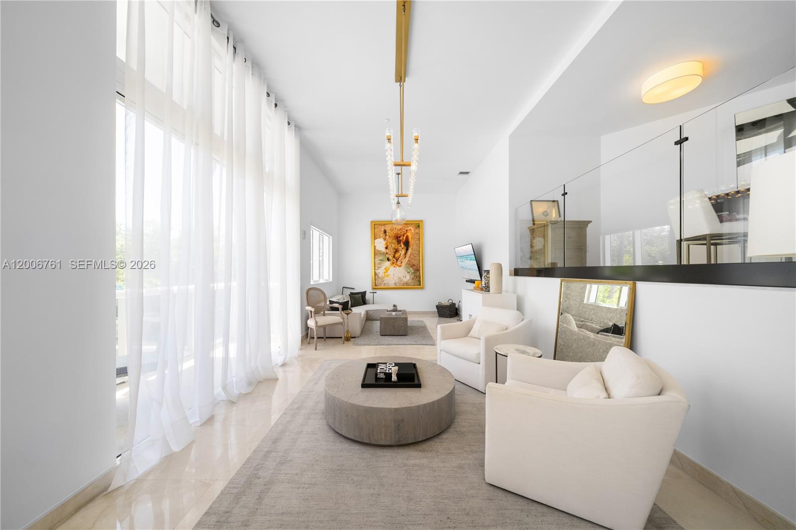 400 Alton Road, Unit TH1A Miami Beach, FL 33139 - Photo 10 of 32 a living room with furniture and a large window