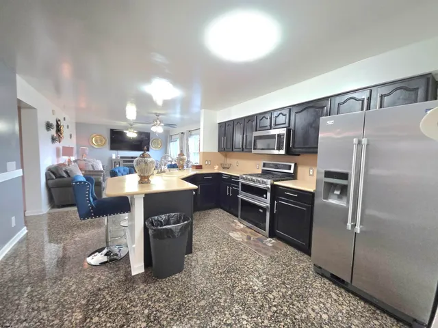 a large kitchen with a table and chairs