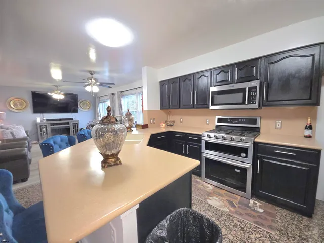 a kitchen with a sink and chandelier