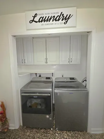 a view of a dining room with furniture and a chandelier