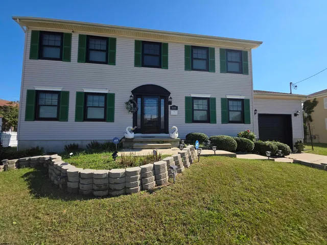 a view of a house with swimming pool and a yard