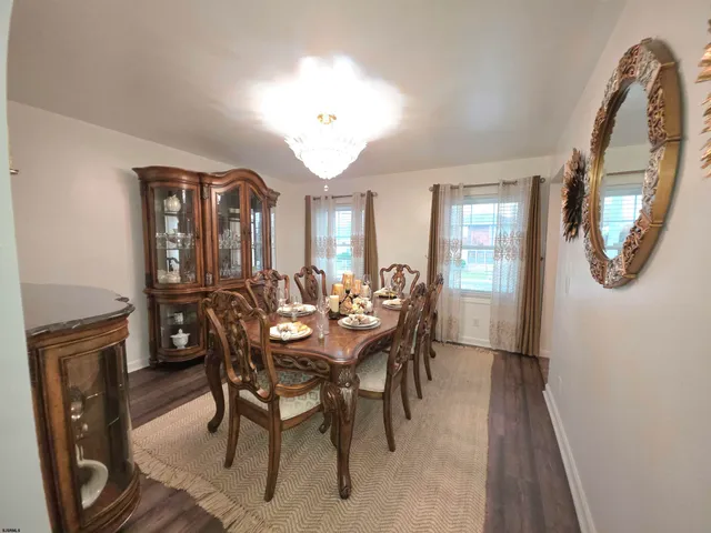 a dining room with furniture and a mirror
