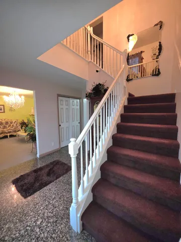 a bedroom with a bed and a large mirror on the dresser