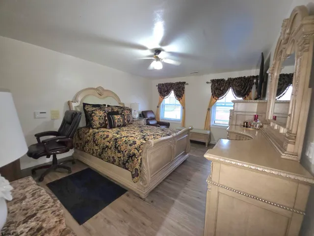 a view of a bedroom with a bed and a chandelier