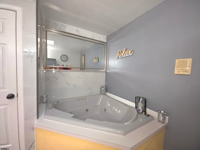 a bathroom with a sink mirror and vanity