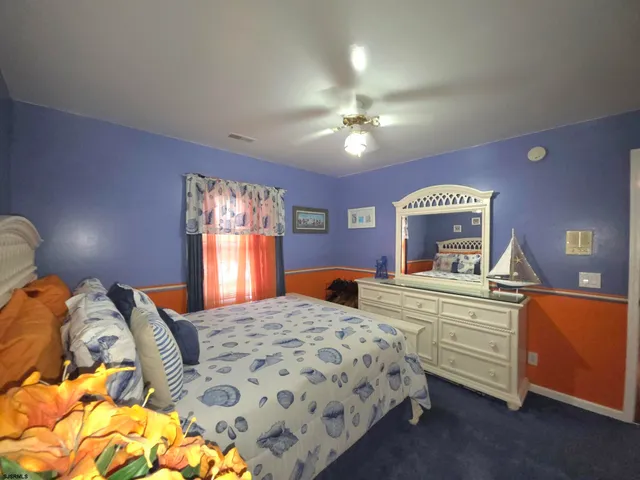 a front view of a house with garden and plants