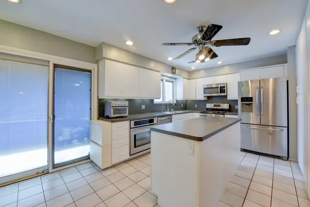 a kitchen with a refrigerator a sink and dishwasher