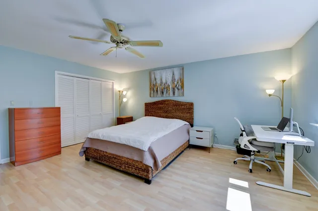 a spacious bedroom with a bed and a chandelier