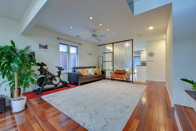 a living room with furniture and a potted plant