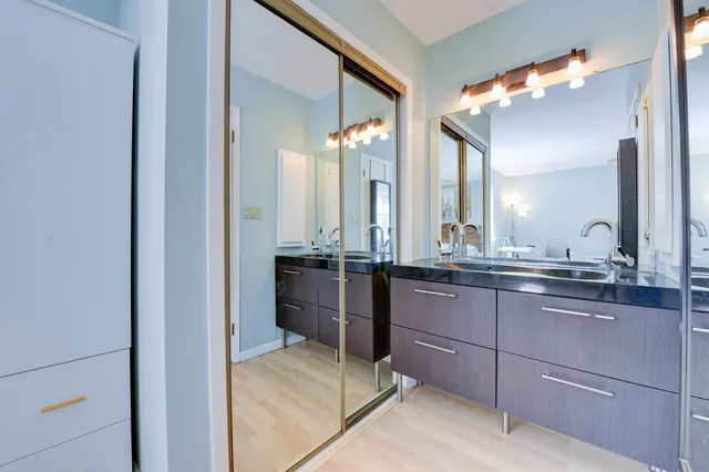 a bathroom with a double vanity sink and a mirror