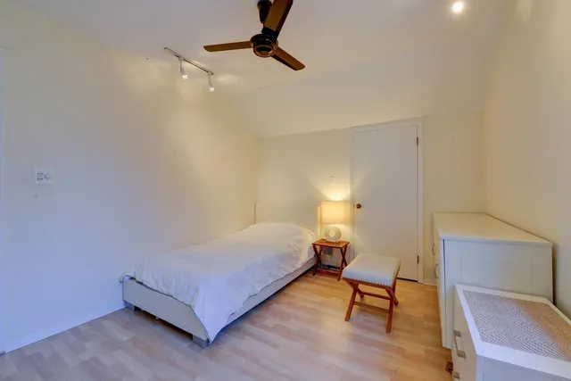 a bedroom with a bed and a chair