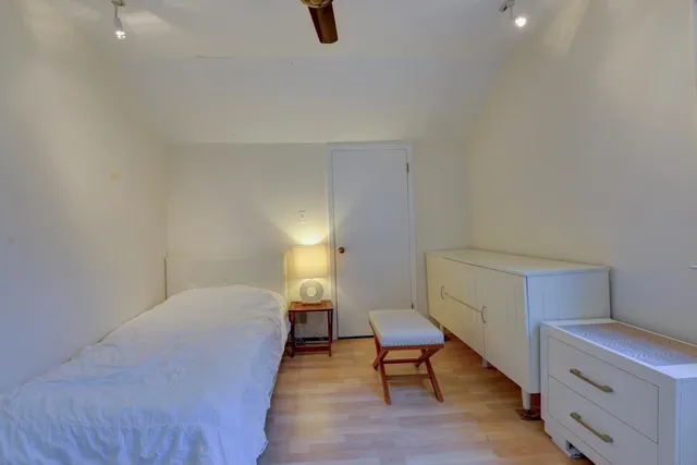 a bedroom with a bed and a chair