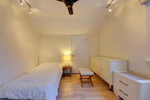 a bed room with a bed and a chair