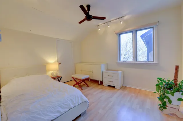 a bedroom with furniture and a large window