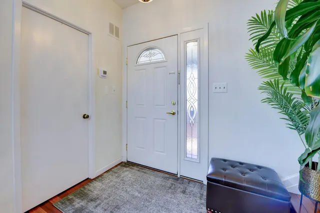a view of an entryway with wooden floor