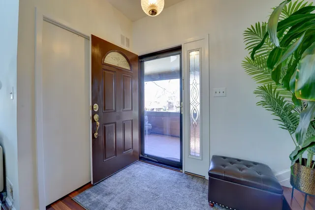 a view of an entryway with wooden floor