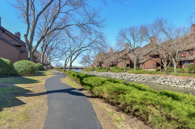 a view of a brick building next to a yard