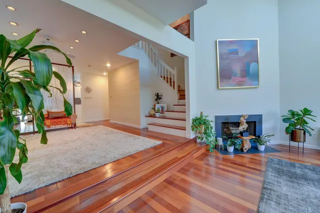 a living room with furniture and a potted plant