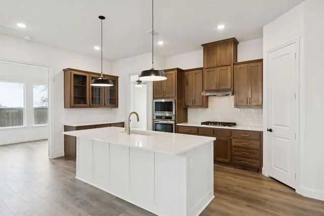 a kitchen with cabinets a sink and appliances