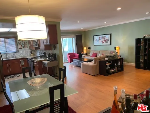 a living room with furniture a flat screen tv and a large window
