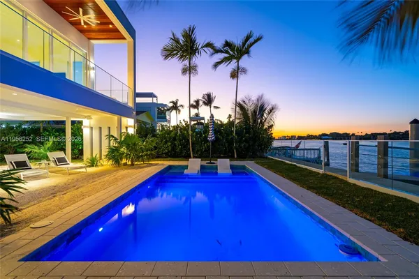 a view of swimming pool with outdoor seating and city view