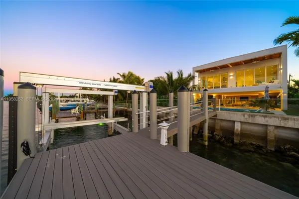 a view of a chairs and table on the wooden deck