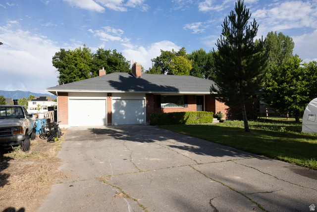 827 South 600 East Logan, UT 84321 - Photo 2 of 30 Brick exterior with a dark-shingled roof and two chimneys