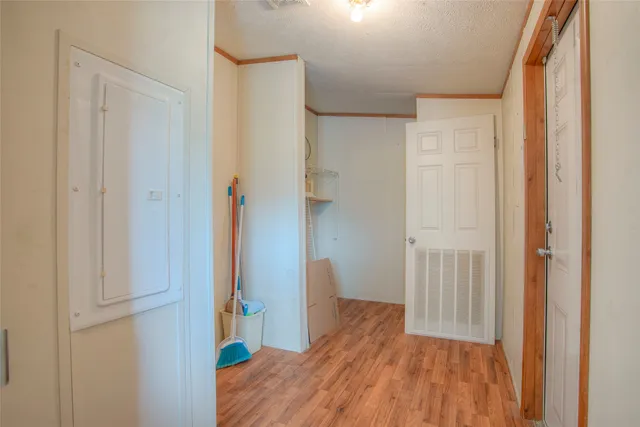 a view of a hallway with wooden floor and entryway