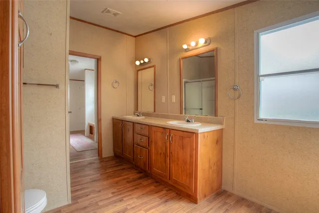 a bathroom with a double vanity sink and a mirror