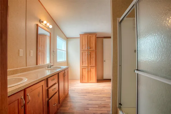a bathroom with a granite countertop sink and a large mirror