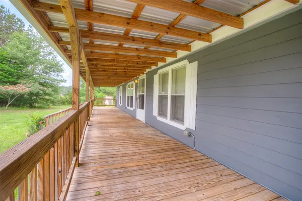 a view of balcony with wooden floor and fence