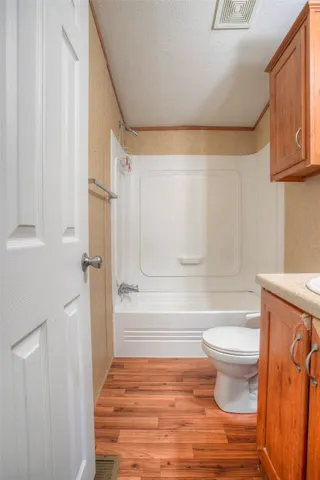 a bathroom with a toilet and a shower curtain