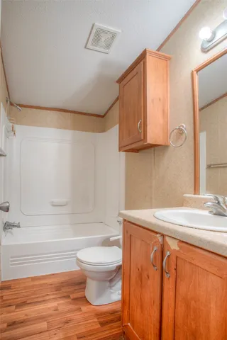 a bathroom with a sink a toilet and bathtub
