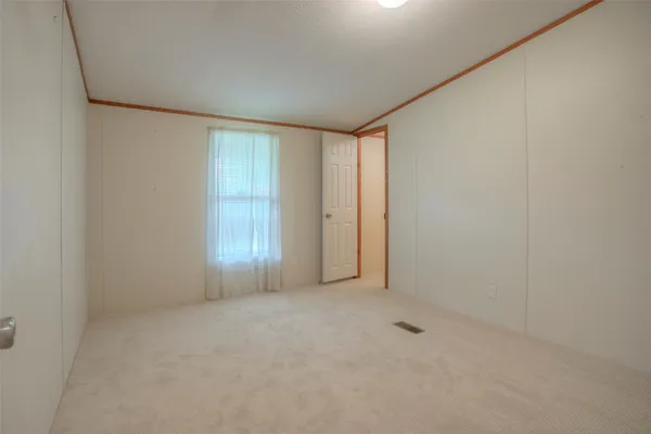 an empty room with closet area