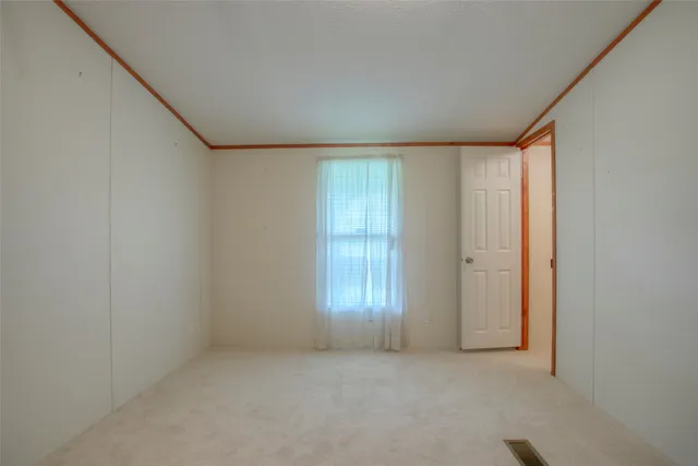 an empty room with closet area