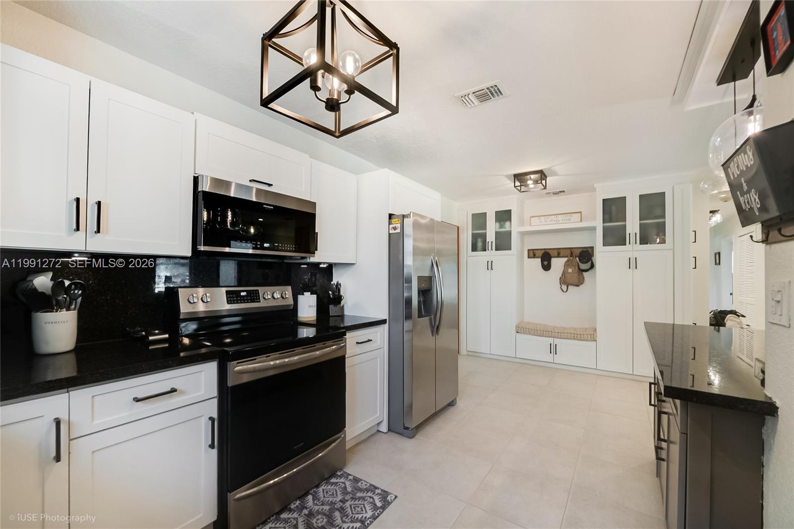 8535 Southwest 97th Road Miami, FL 33173 - Photo 4 of 28 a kitchen with stainless steel appliances a refrigerator a stove a microwave and cabinets