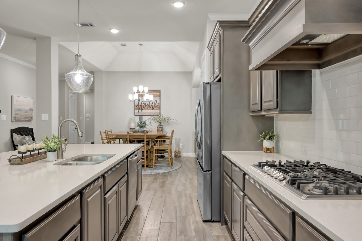 334 Torrey Bloom Loop Conroe, TX 77304 - Photo 14 of 46 Kitchen features gas cooktop and spacious island with sink.