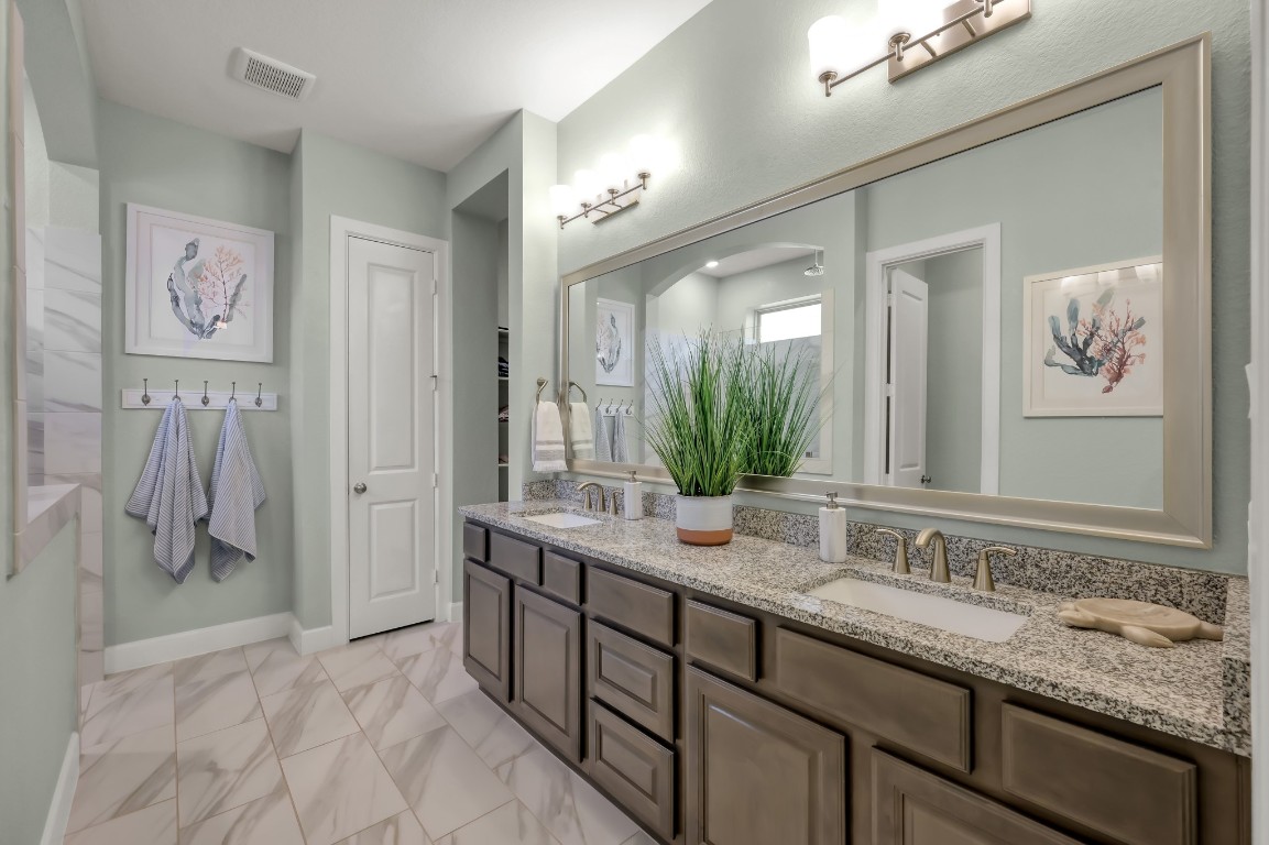 334 Torrey Bloom Loop Conroe, TX 77304 - Photo 23 of 46 Primary bath with dual vanities, granite countertops, and ample storage—designed for both comfort and functionality.