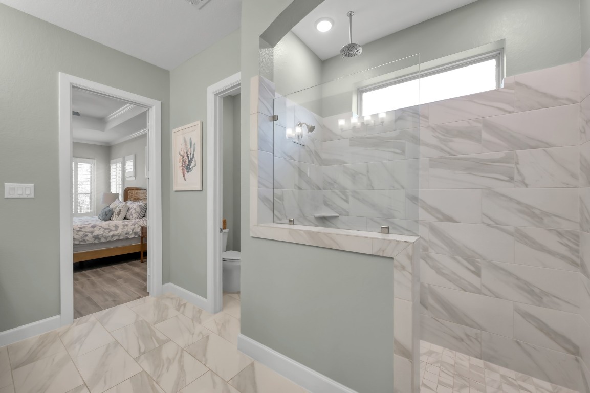 334 Torrey Bloom Loop Conroe, TX 77304 - Photo 24 of 46 Spa-like primary bath featuring oversized walk-in shower with designer tile, glass enclosure, and modern finishes for a luxurious retreat.