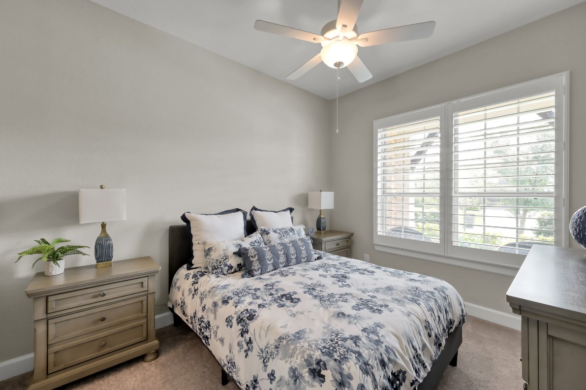 334 Torrey Bloom Loop Conroe, TX 77304 - Photo 25 of 46 Bright secondary bedroom with plantation shutters, soft natural light, and cozy, neutral finishes.