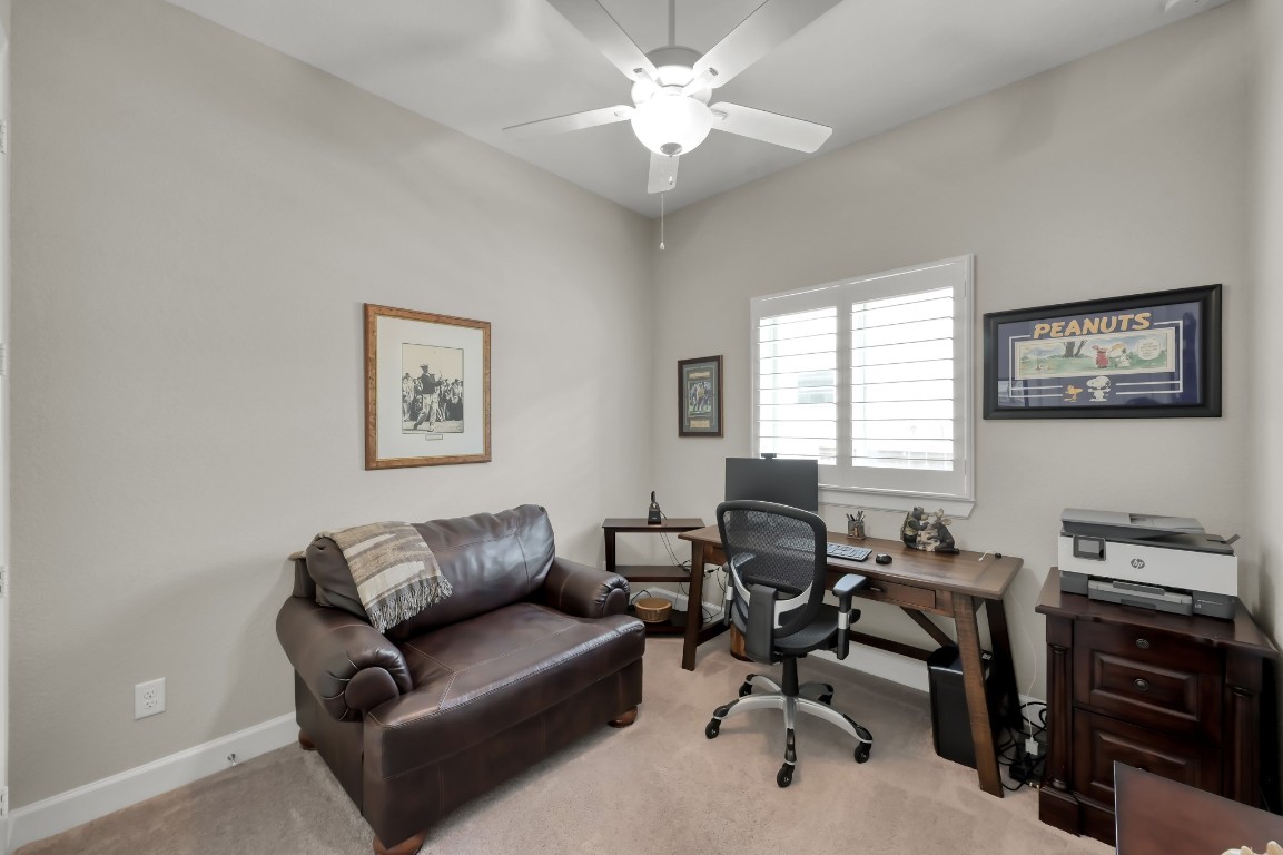 334 Torrey Bloom Loop Conroe, TX 77304 - Photo 27 of 46 Versatile secondary bedroom currently used as a home office, featuring natural light, neutral tones, and flexible functionality.