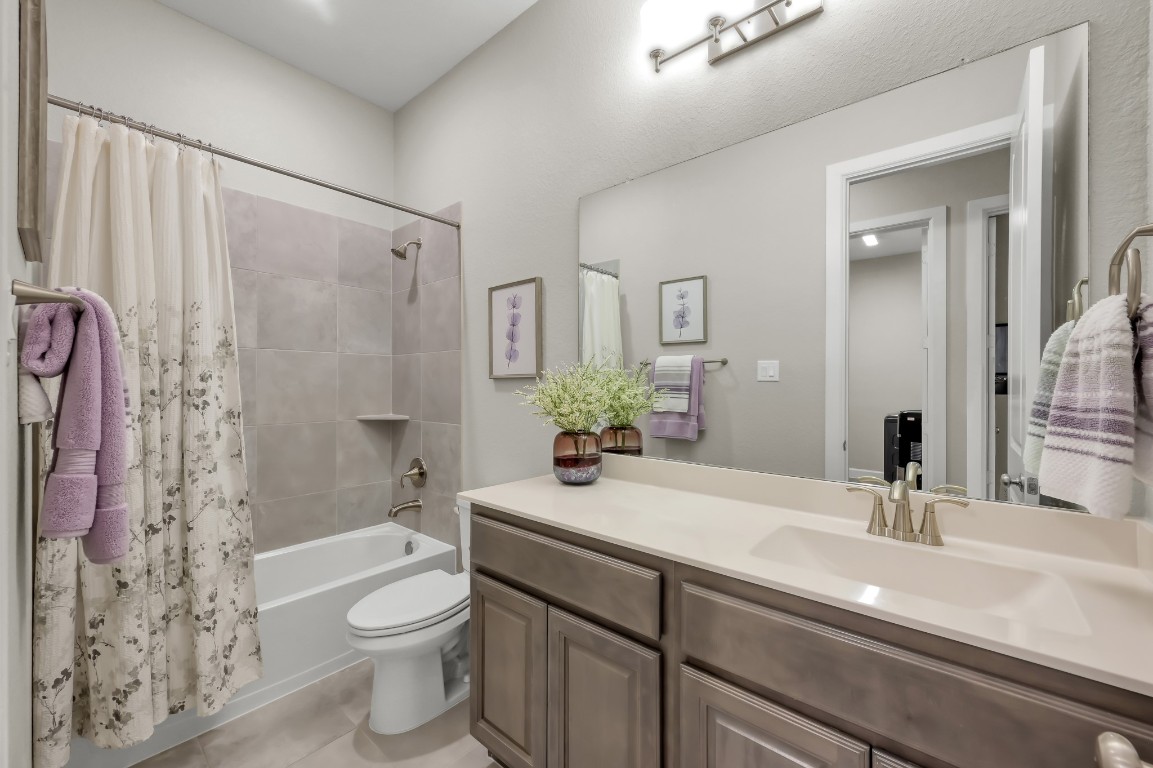 334 Torrey Bloom Loop Conroe, TX 77304 - Photo 28 of 46 Spacious secondary bath with tub/shower combo, extended vanity, and neutral finishes—ideal for guests or family use.