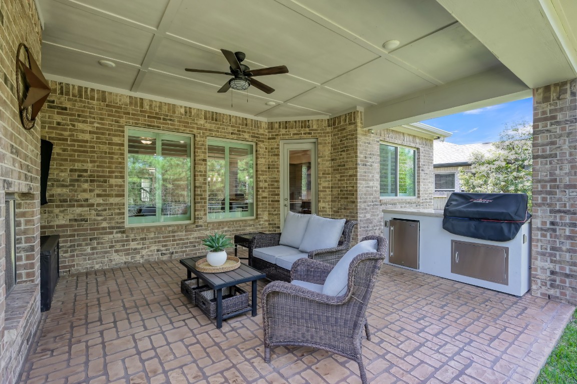 334 Torrey Bloom Loop Conroe, TX 77304 - Photo 34 of 46 Covered patio with Custom outdoor grilling station with built-in BBQ grill and mini refrigerator.